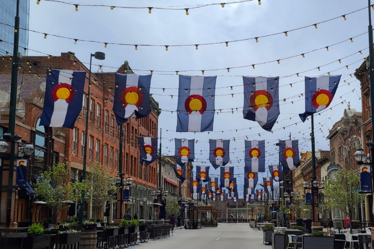 photo of street on Larimer Square in Denver, Colorado with Colorado flags hanging from wires above the street