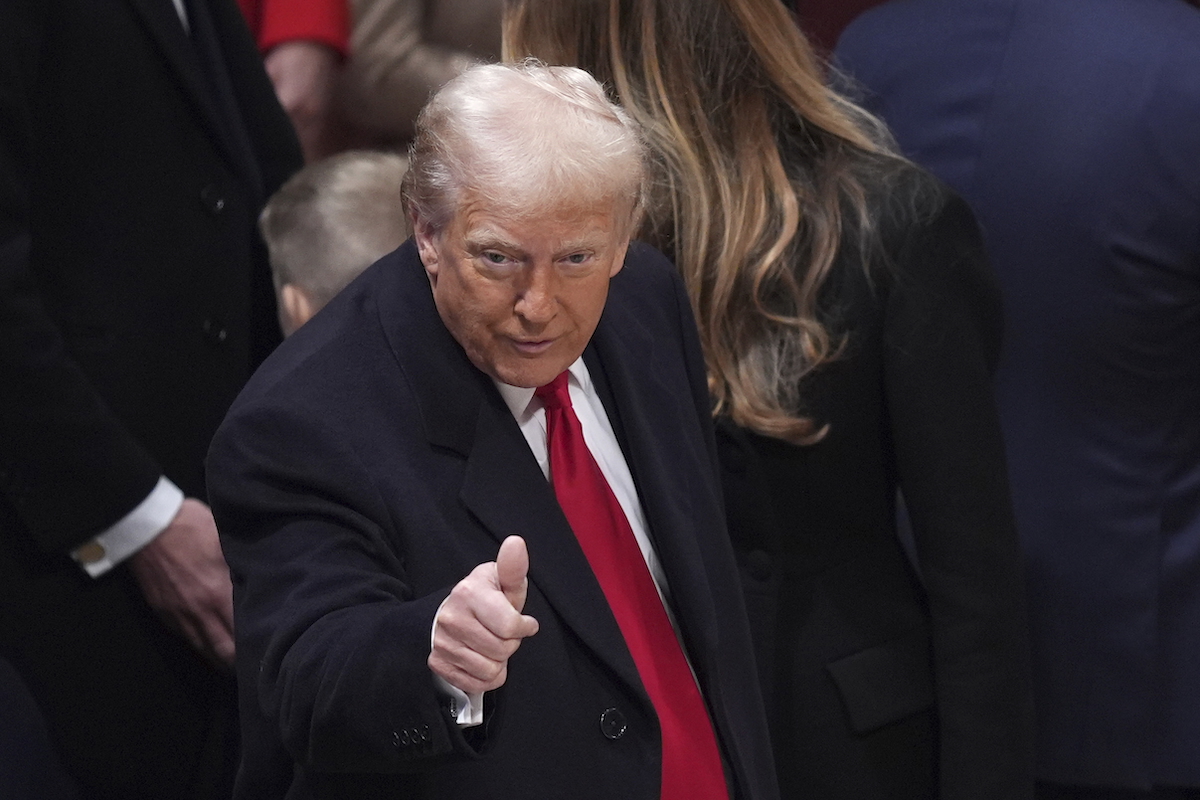 close up of Donald Trump as he gives a thumbs up to a crowd