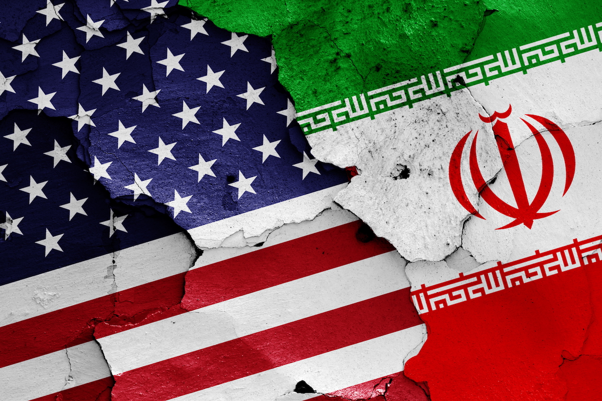 concept image of U.S. and Iranian flags depicted on a cracked surface, implying rivalry